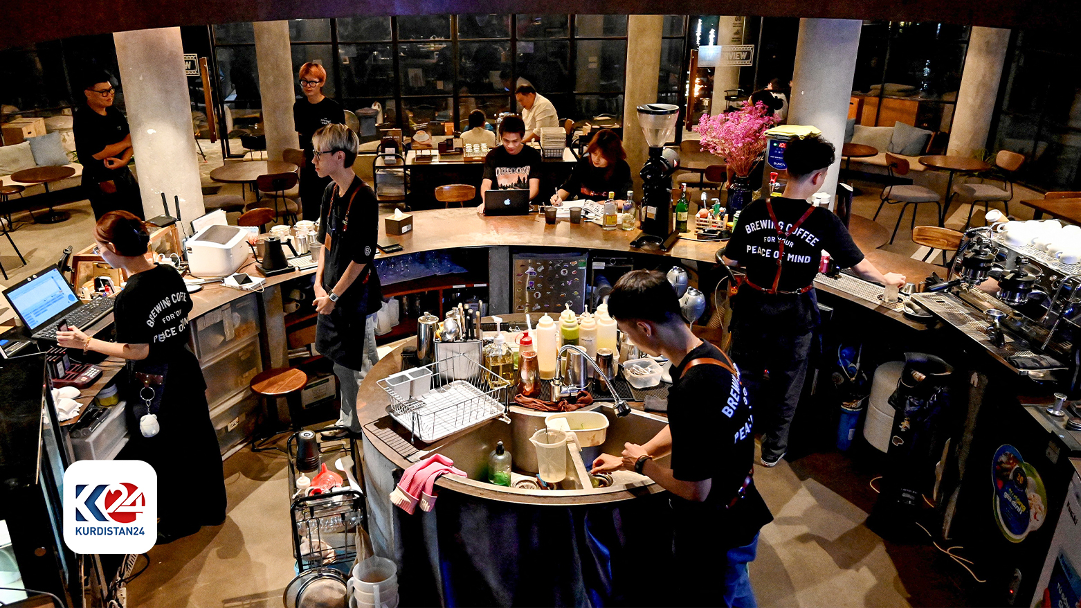 This photo taken on August 21, 2024 shows coffee house employees working at a cafe in Hanoi. (Photo: AFP)