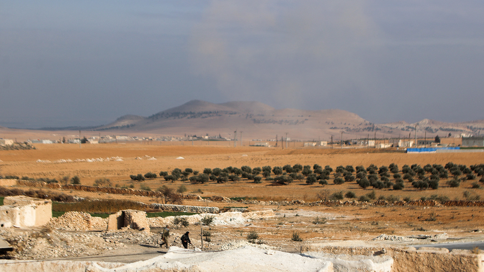 Smoke billows in the distance at a position near the Tishrin Dam in the vicinity of Manbij. (Photo: AFP)