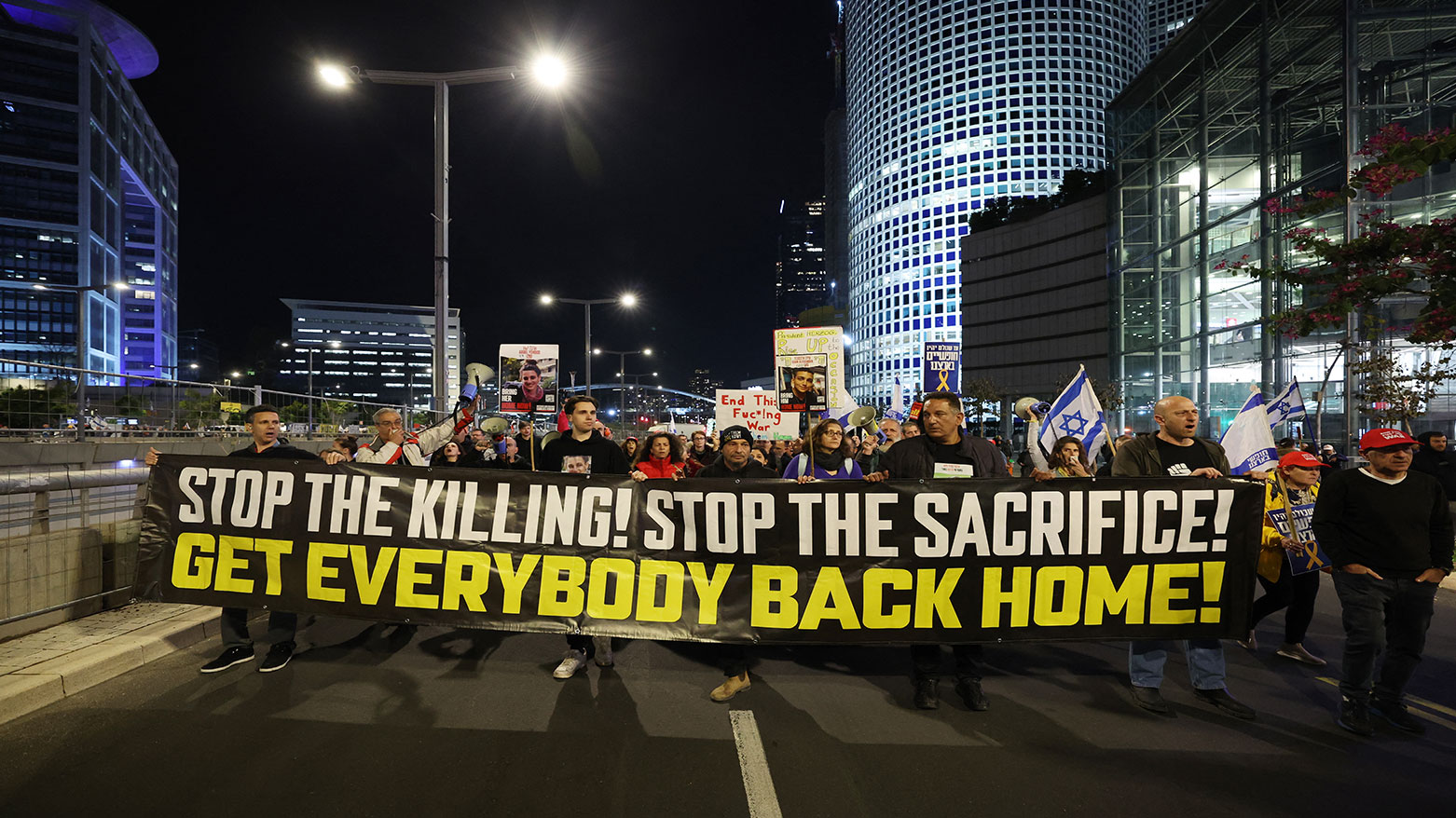 Demonstrators raise placards and wave flags during a protest calling for the release of hostages held captive in Gaza since Oct. 7, 2023, in front of the Israeli Defence Ministry in Tel Aviv on Jan. 25, 2025. (Photo: AFP)
