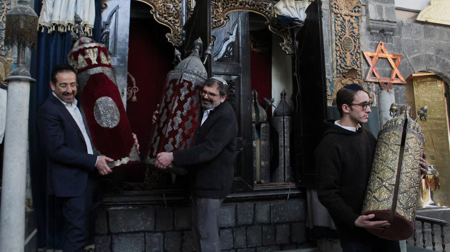 Henry Hamra and members of a Syrian Jewish delegation who are visiting Syria for the first time in decades hold a Torah Case in a Jewish synagogue in Damascus, Syria Feb. 18, 2025. (Photo: REUTERS)