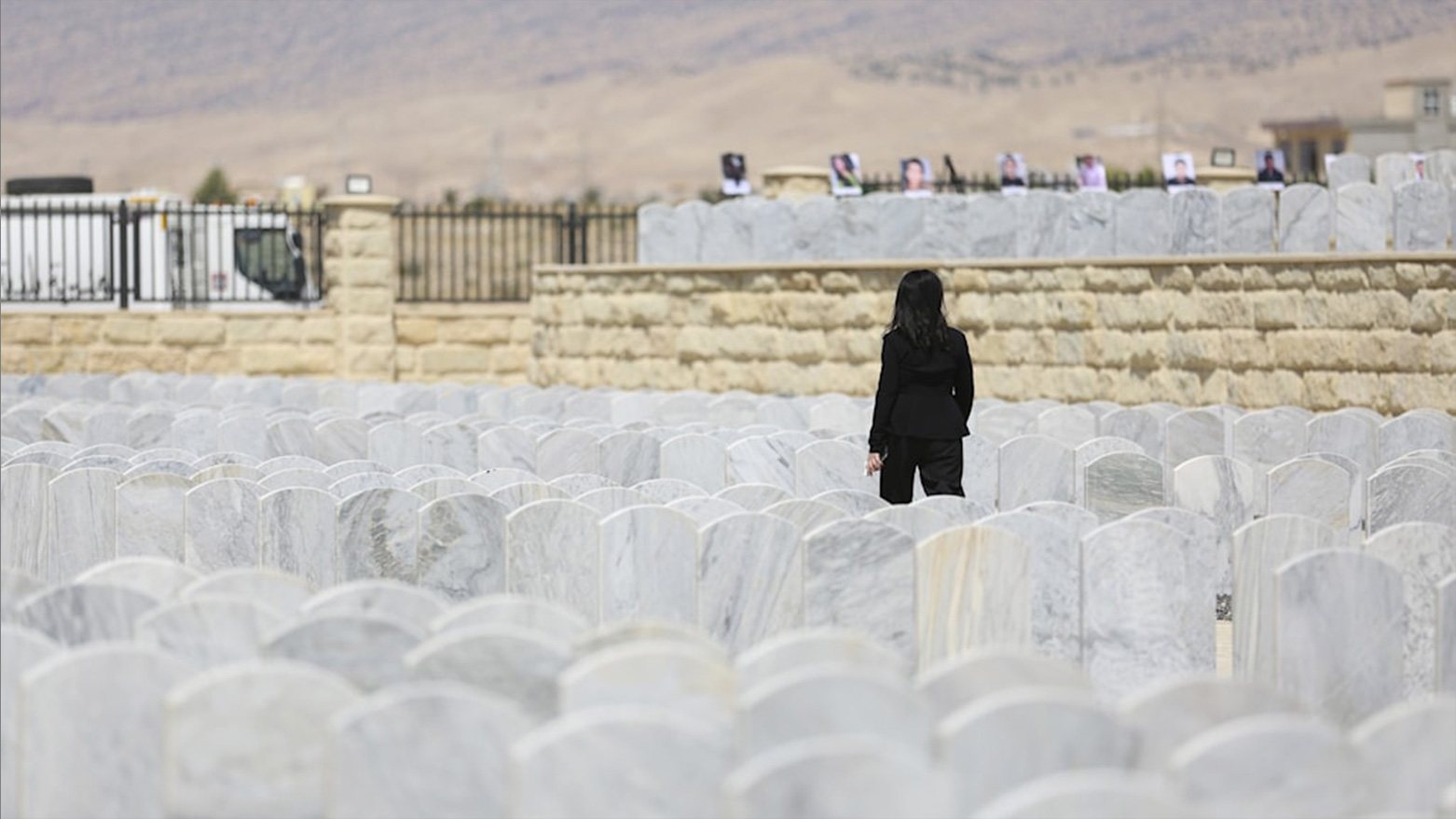 An Iraqi Yazidi woman visits her relatives in the cemetery during a commemoration of the 10th anniversary of Yazidi genocide in Sinjar. (Photo: AP)