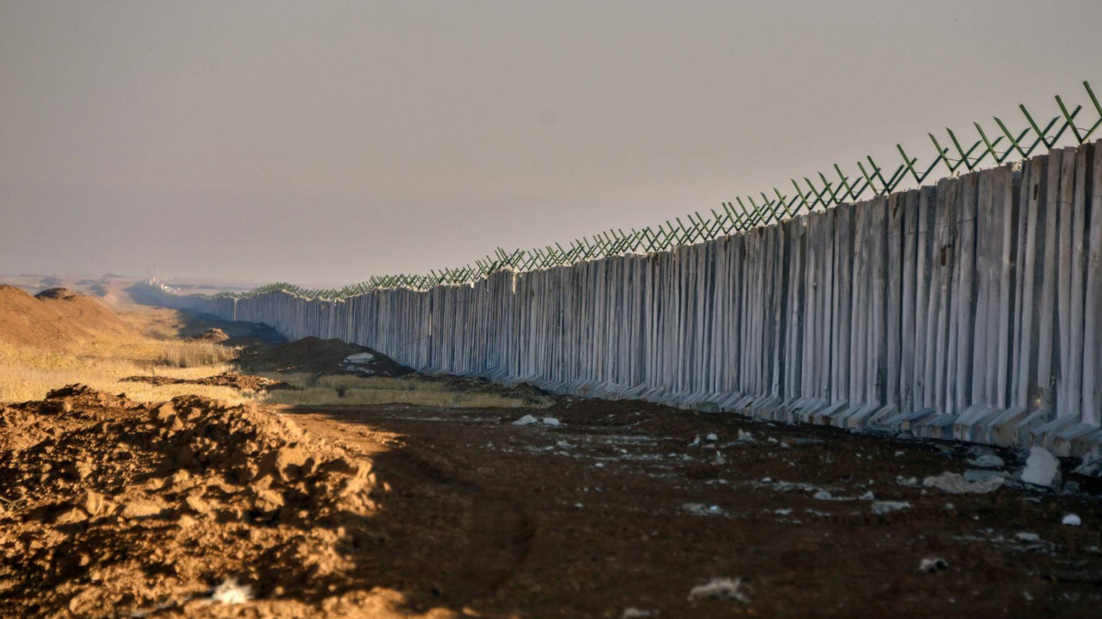 A cement barrier stands along  Iraqi border with Syria, on December 26, 2024. (Photo: AFP)