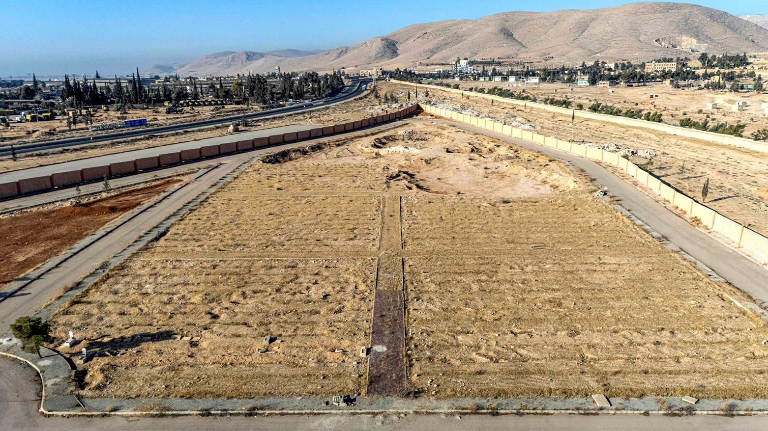 This aerial view shows a site believed to be a mass grave near Baghdad Bridge in Adra, about 35 kilometres east of Damascus, on Dec. 25, 2024. (Photo: Sameer Al-DOUMY/AFP)