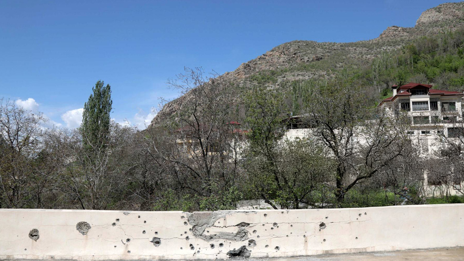 This picture taken on April 25, 2023, shows a shrapnel-pocked walled in the village of Hiror near the Turkish-Kurdistan Region border. (Photo: AFP)