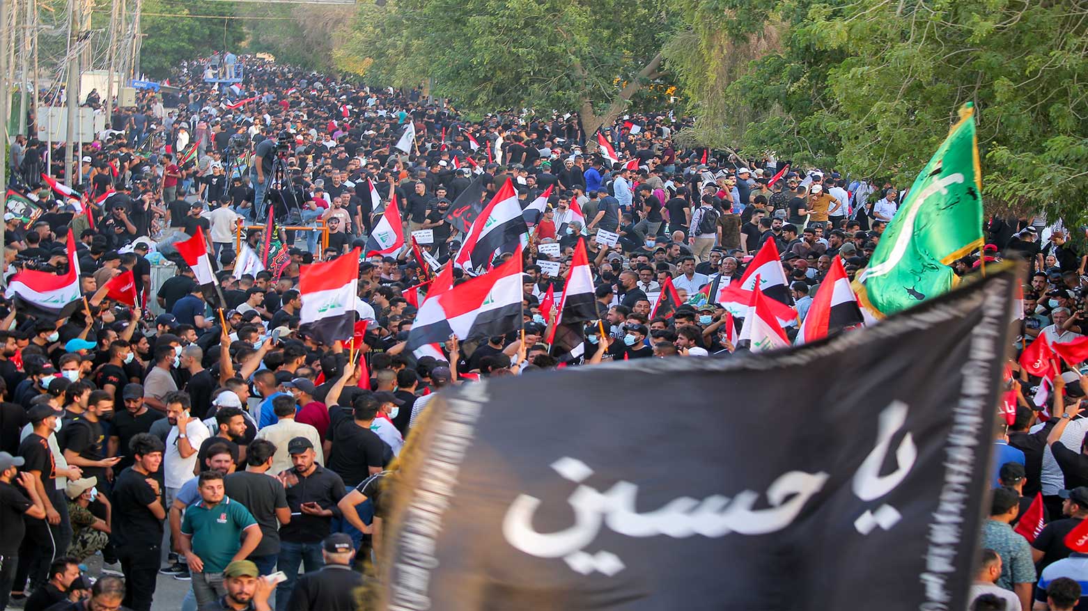 Supporters of Iran-backed Shiite Coordination Framework attend a rally to denounce their rivals, followers of an influential Shiite cleric Muqtada al-Sadr, in Baghdad, Iraq, Friday, Aug. 12, 2022. (Photo: AP)