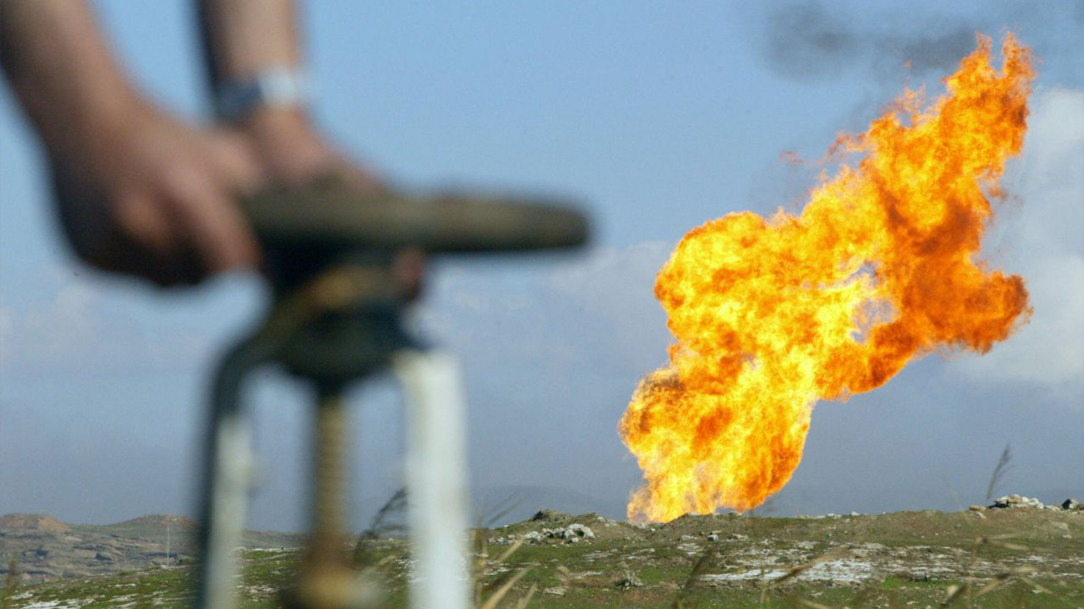 A worker turning a valve at the Shirawa oilfield, where oil was first pumped in Iraq in 1927, outside the city of Kirkuk. (Photo: AFP)