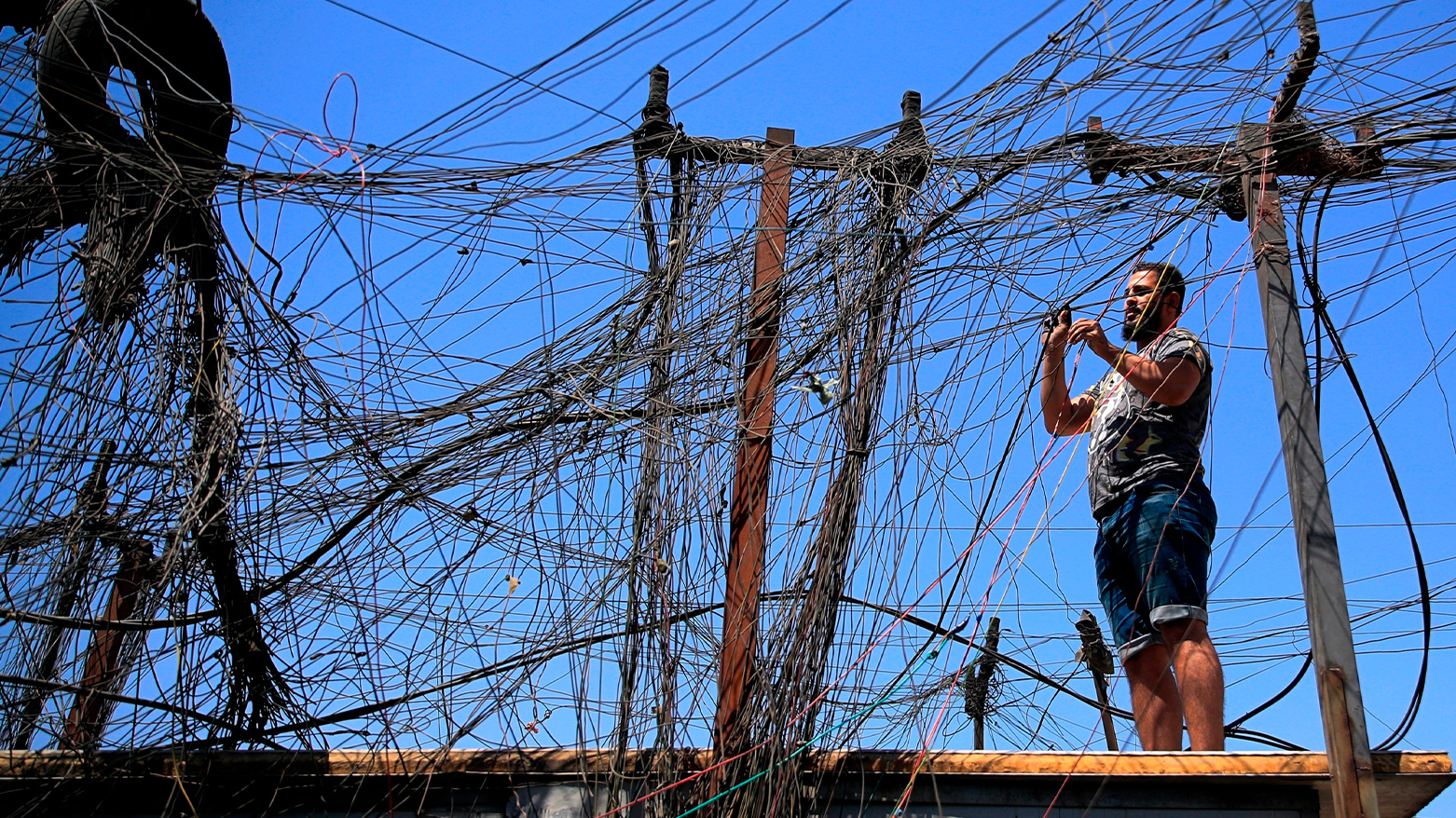 Muqtada Haider turns the switches to transfer electricity to private homes in Baghdad, Iraq, on Sept. 10, 2021. (Photo: AP)