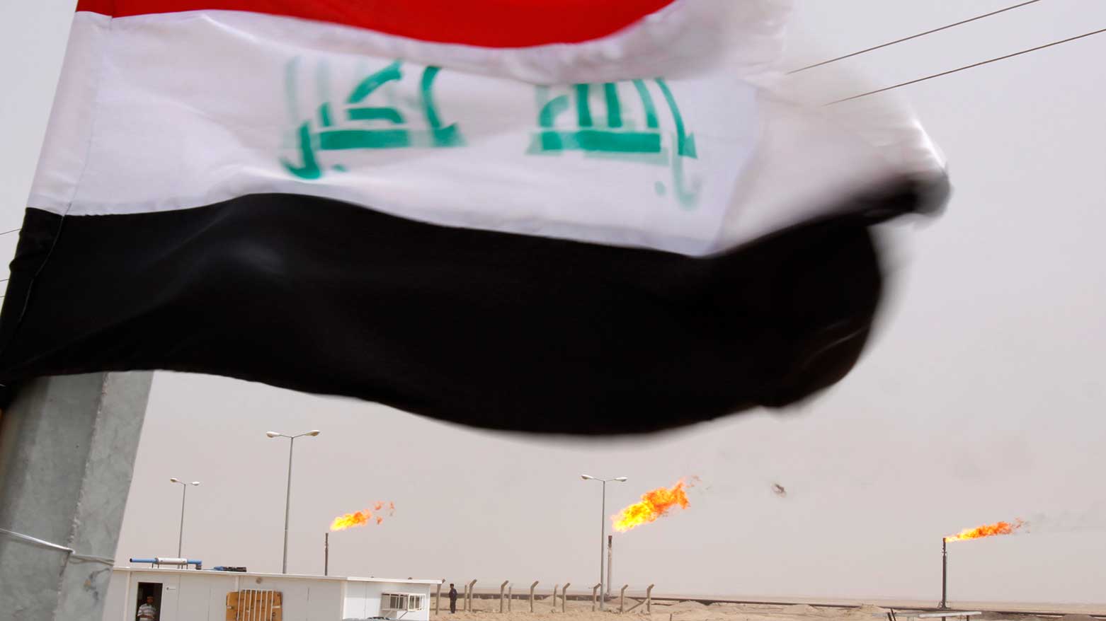 The Iraqi national flag flies over a newly inaugurated gas processing facility at Tuba oil field in the southern oil-rich province of Basra, Iraq, June 4, 2011.  (Photo: AP)