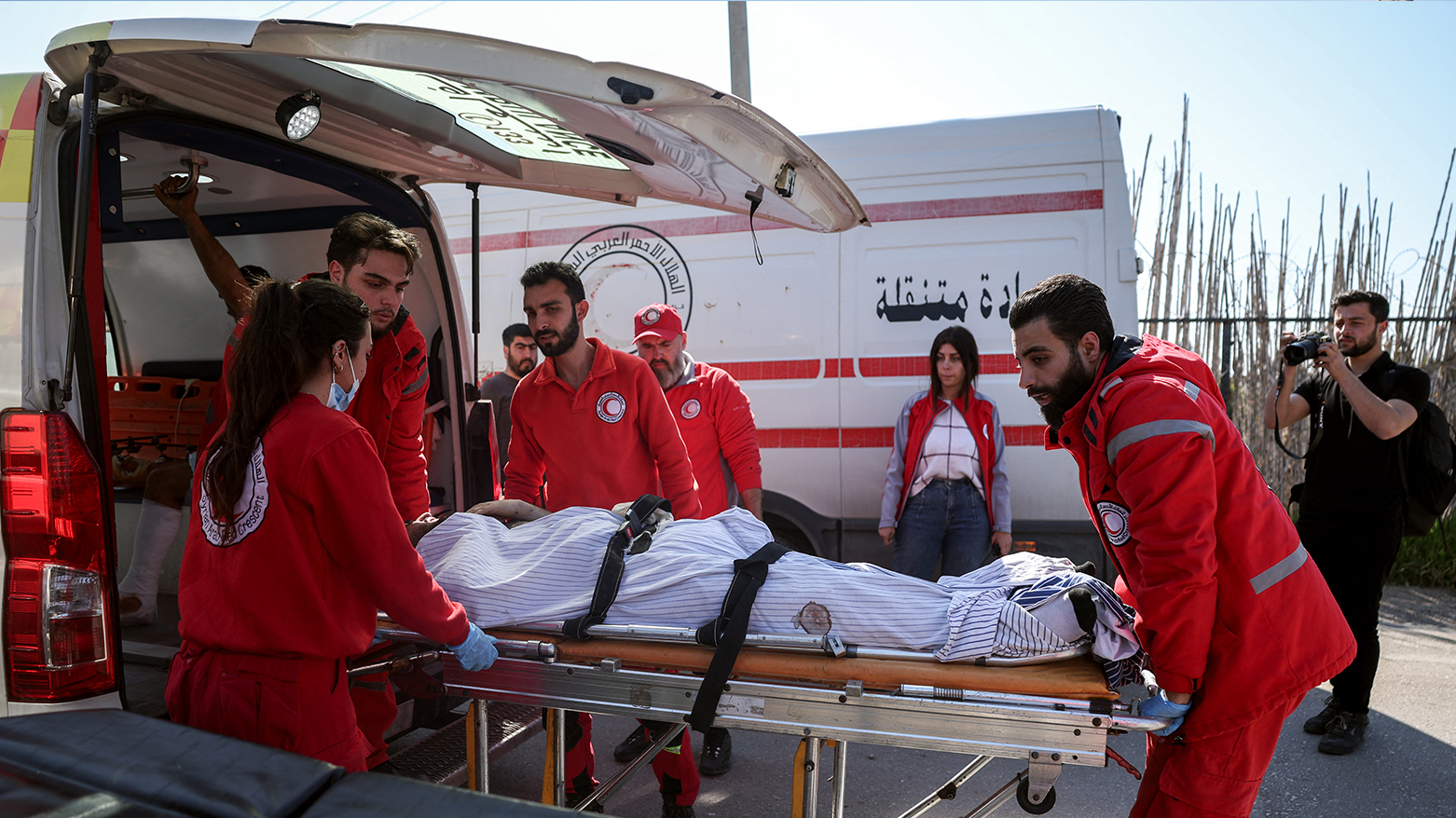 Syrian Red Crescent members evacuate wounded civilians who took refuge from violence in the Hmeimim Russian base in Syria's Latakia Mediterranean province, on Mar. 11, 2025.(Photo: AFP)