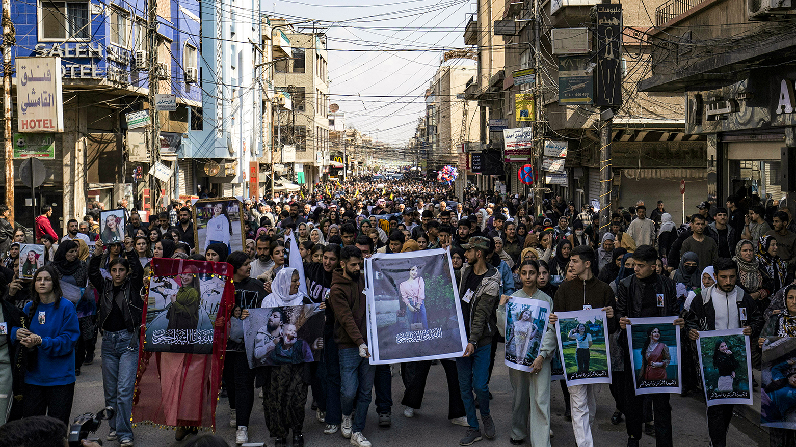 TOPSHOT - People march with pictures of victims of a recent wave of sectarian violence targeting Syria's Alawite during a protest condemning the attacks in city of Qamishli Rojava, Mar. 11, 2025. (Photo: AFP)