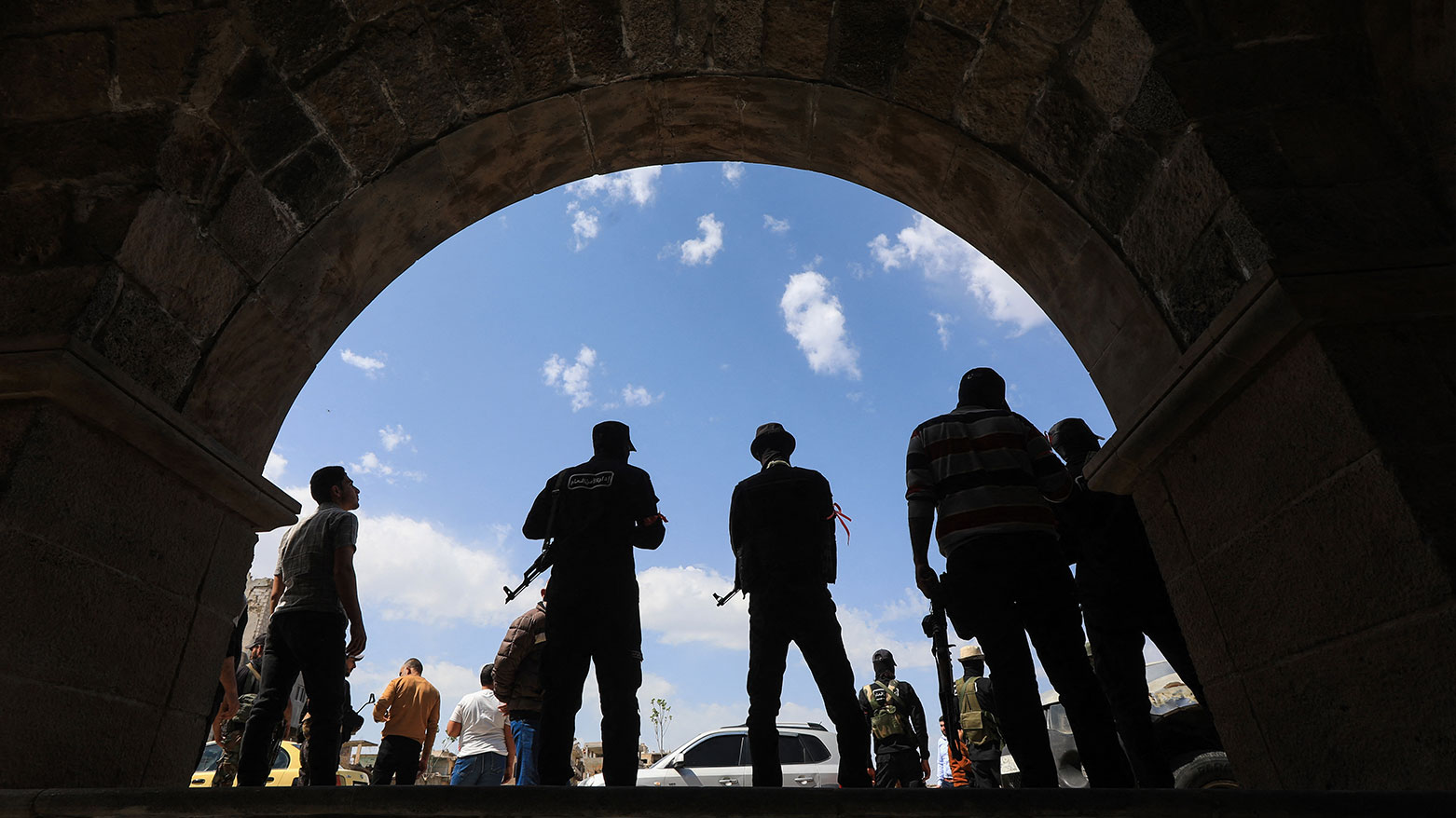 Members of Syria's security forces stand guard during the funeral of three people killed in Israeli strikes a day earlier, in the southern town of Daraa on Mar. 18, 2025.(Photo: AFP)