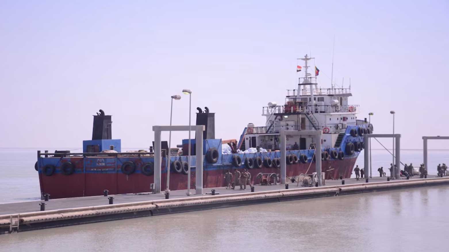 Officers from the Naval Force Command stand near an unidentified vessel in Iraqi regional waters suspected of smuggling fuel in Umm Qasr, Iraq, March 18, 2025. (Photo: Iraqi Naval Forces)