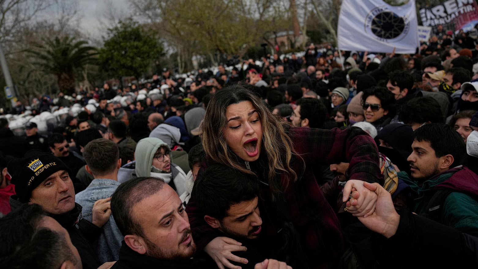 A woman is helped to leave during scuffles between anti riot police officers and people who protest the arrest of Istanbul Mayor Ekrem Imamoglu, in Istanbul, Turkey, March 20, 2025. (Photo: AP)