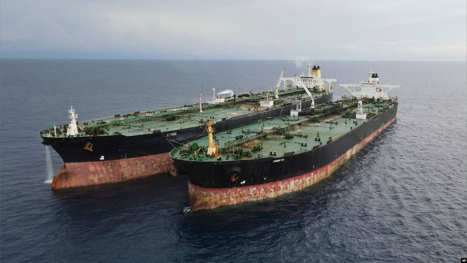 In this undated photo released July 11, 2023, by the Indonesian Maritime Security Agency, Iranian-flagged tanker MT Arman 114, right, and Cameroon-flagged tanker, MT S Tinos, are seen after they are caught conducting illegal oil transfers. (Photo: AFP)