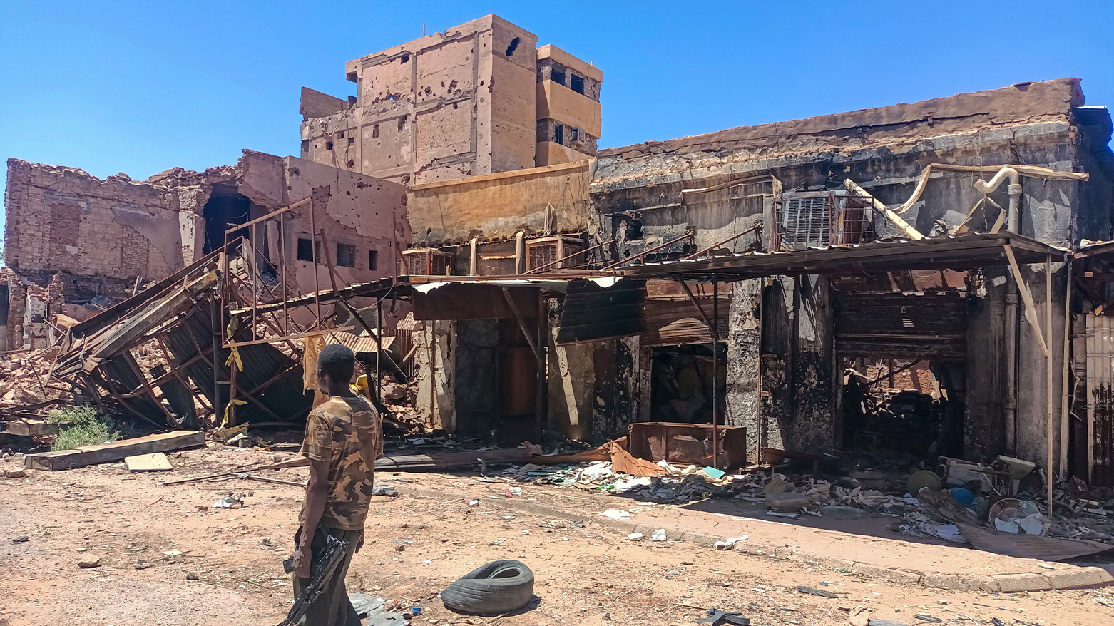 A fighter loyal to the army patrols a market area in Khartoum on March 24, 2025. (Photo: AFP)