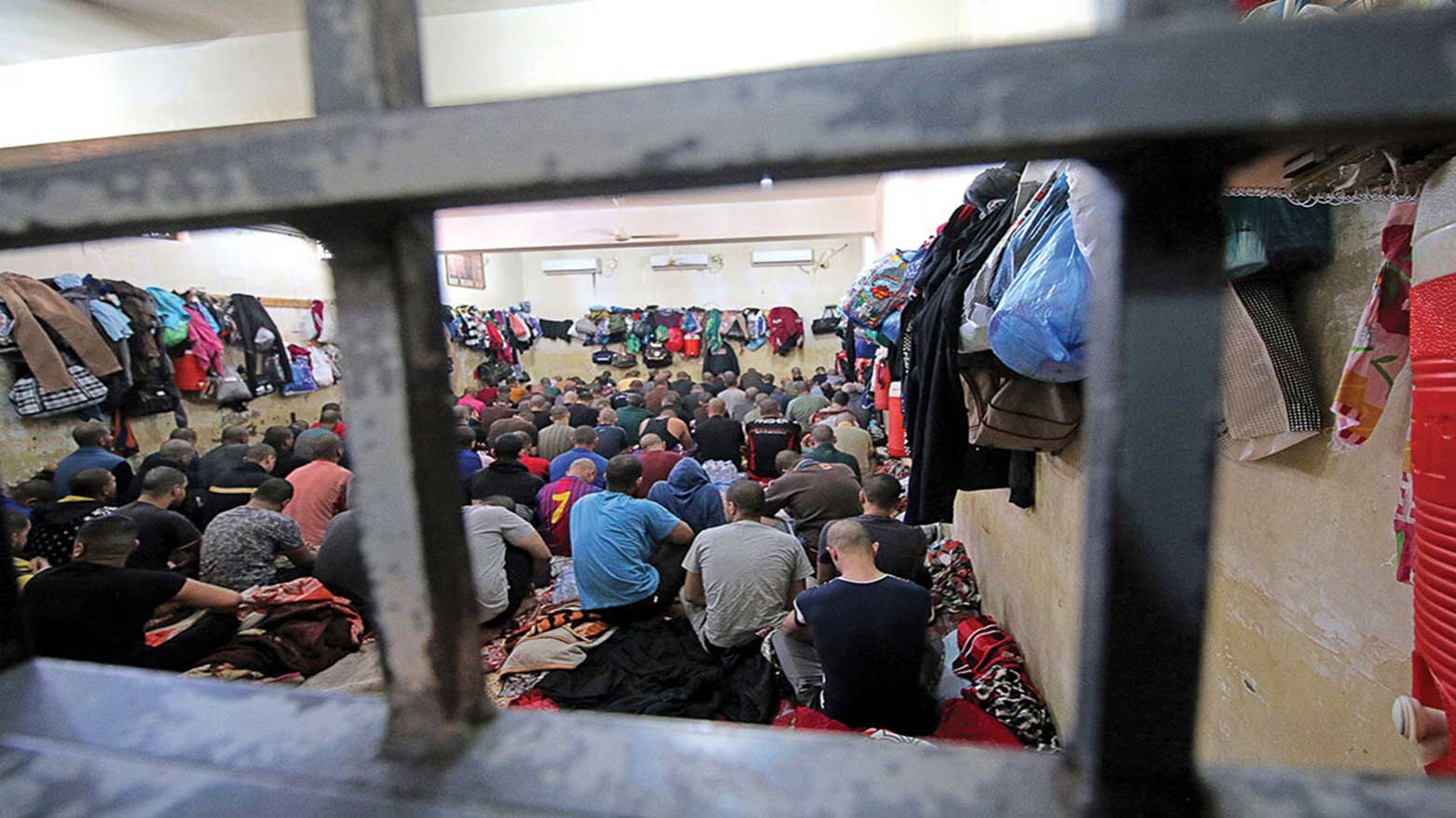 Iraqis arrested on drug charges sit in a cell at a police station in Basra. (Photo: The Independent)