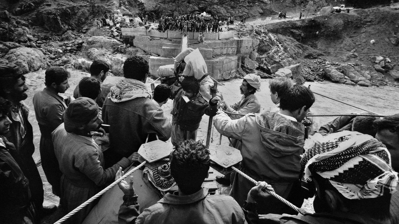Kurds trying to cross the Little Zab River on a makeshift bridge. (Photo: Adam Hinton)