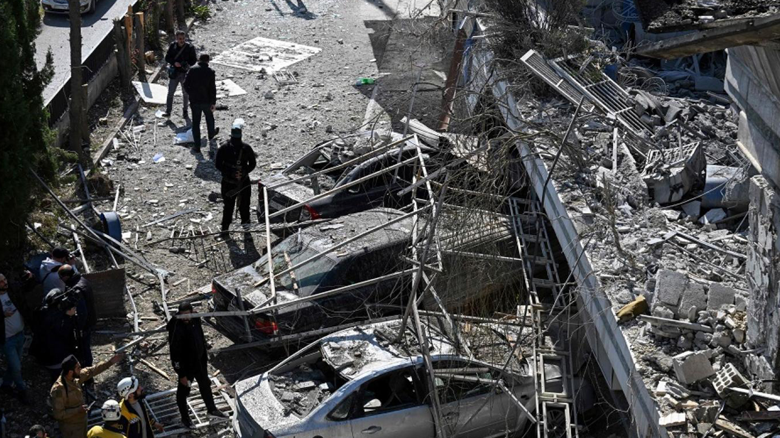 Syrian White Helmets rescuers and security forces check the site of an Israeli air strike on a building in Damascus in an area where Palestinian leaders are known to reside, on Mar. 13, 2025. (Photo: AFP)