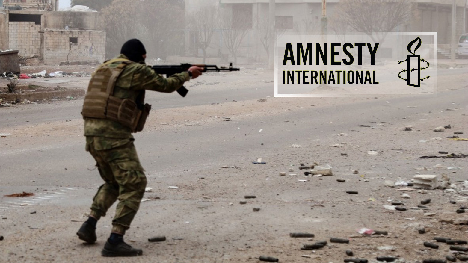 AN armed unidentified person shooting from an AK47, along side Amnesty International logo. (Photo: Designed by Kurdistan24)