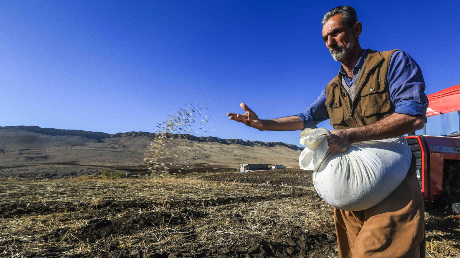 A Kurdish farmer planting seeds at his farm. (Photo: Kurdistan24)