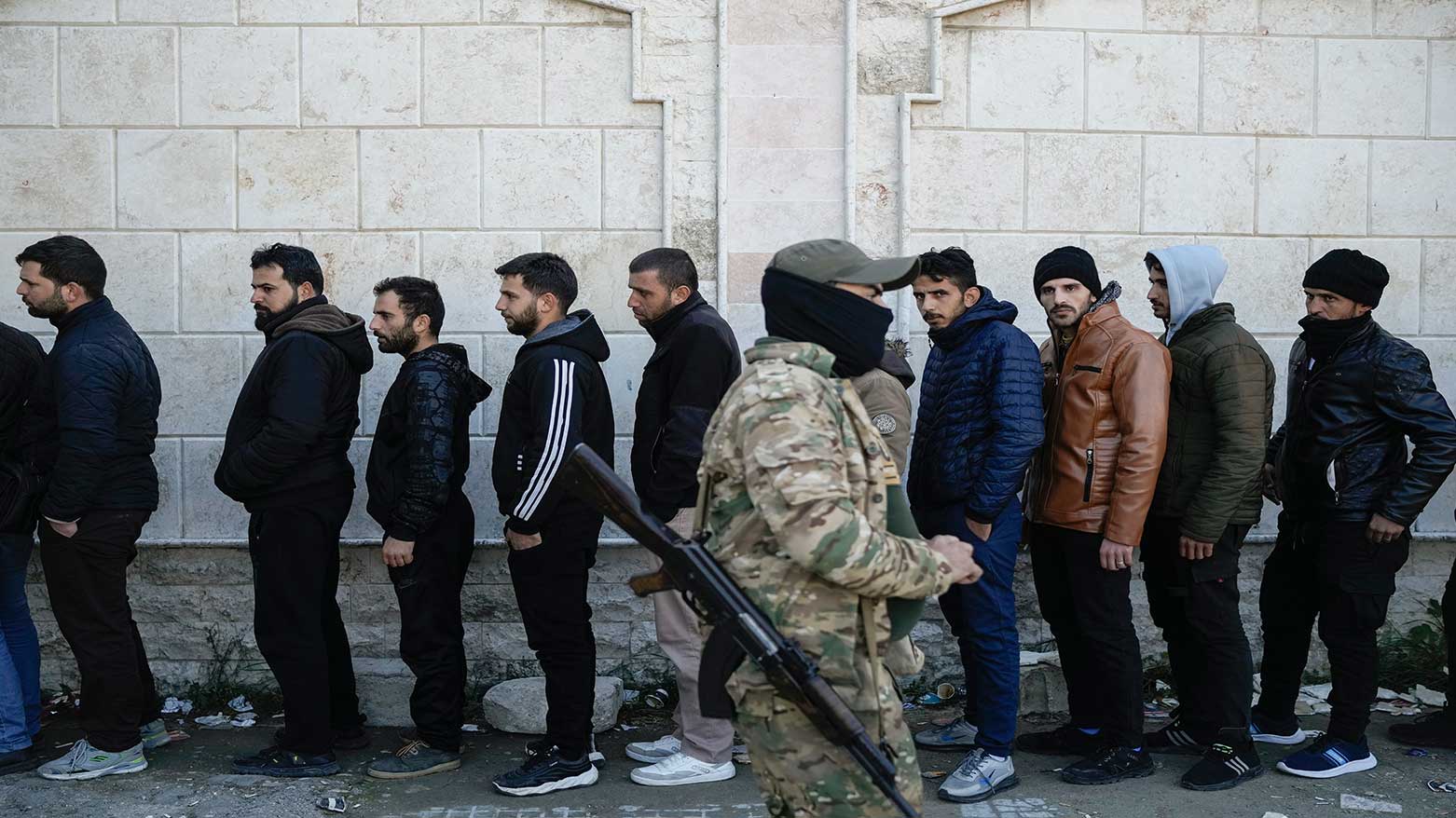 Members from Bashar Assad's Syrian army period line up to register with Syrian rebels as part of a "identification and reconciliation process" at a army compound in Latakia, Syria, Dec. 17, 2024. (Photo: AP)