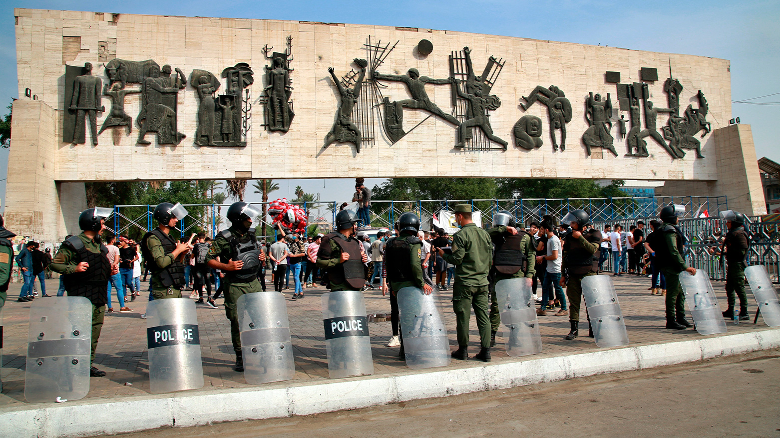 Riot police stand guard in Tahrir Square during a demonstration calling for the government to resign, in Baghdad, Iraq, Sunday, Nov. 8, 2020. (Photo: AP)