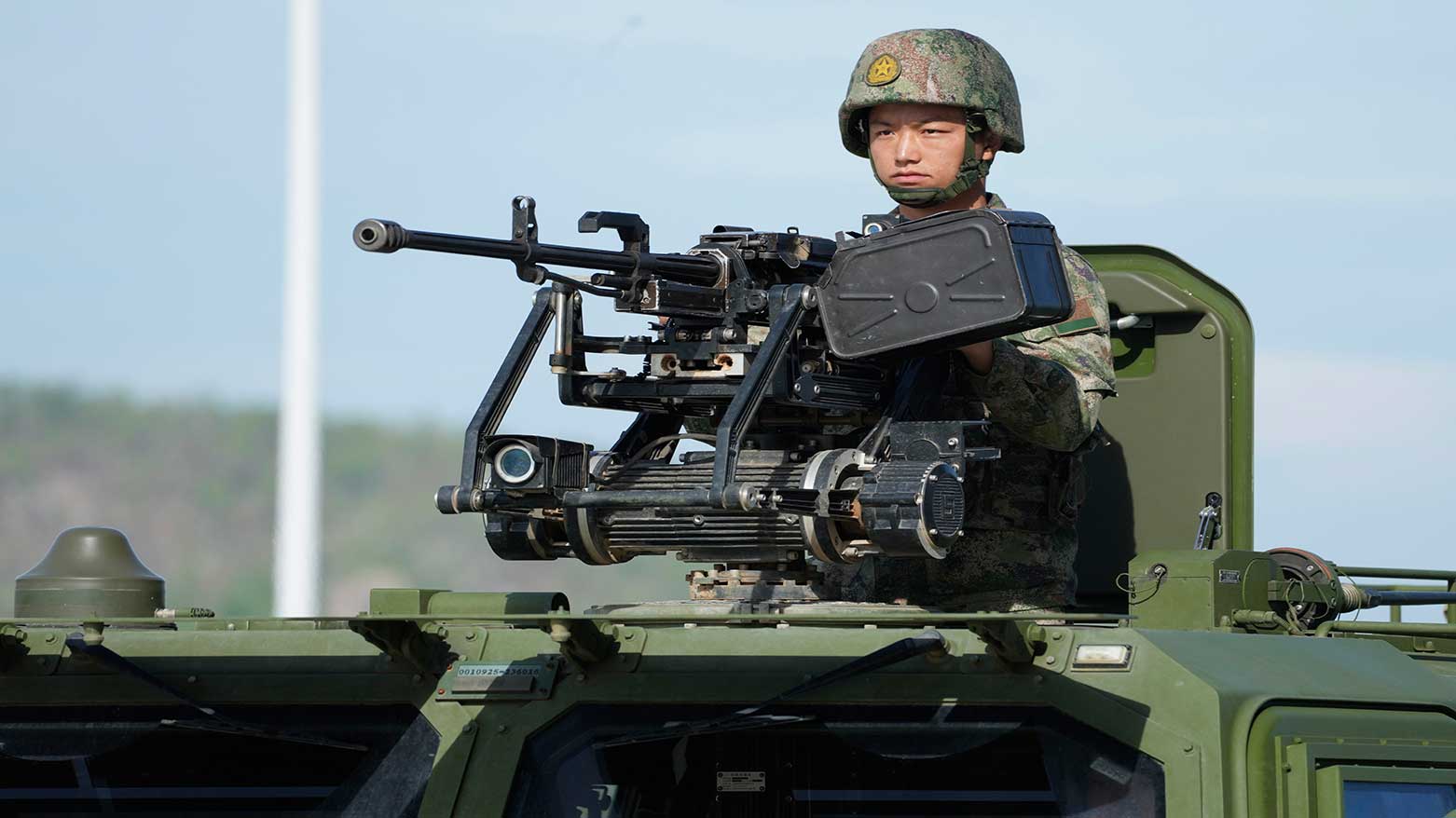 A Chinese army soldier sits with a weapon on an armored fighting vehicle during the Golden Dragon military exercise in Cambodia, May 30, 2024. (Photo: AP)