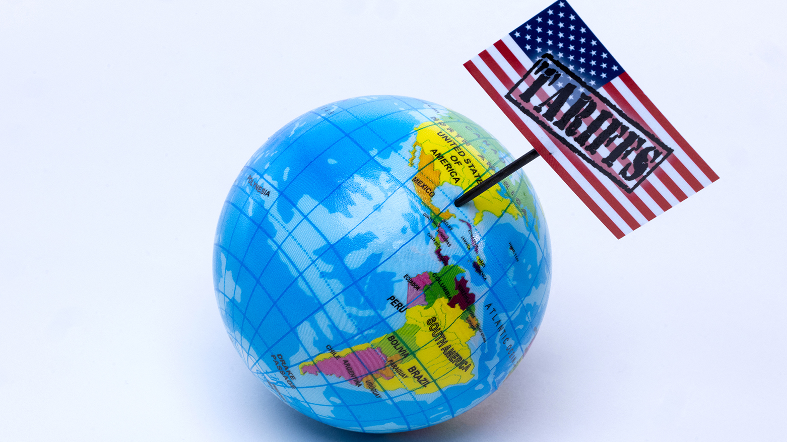 This photograph taken in Paris on April 8, 2025 shows a globe with a USA flag with the inscription "tariffs" planted on it. (Photo: AFP)