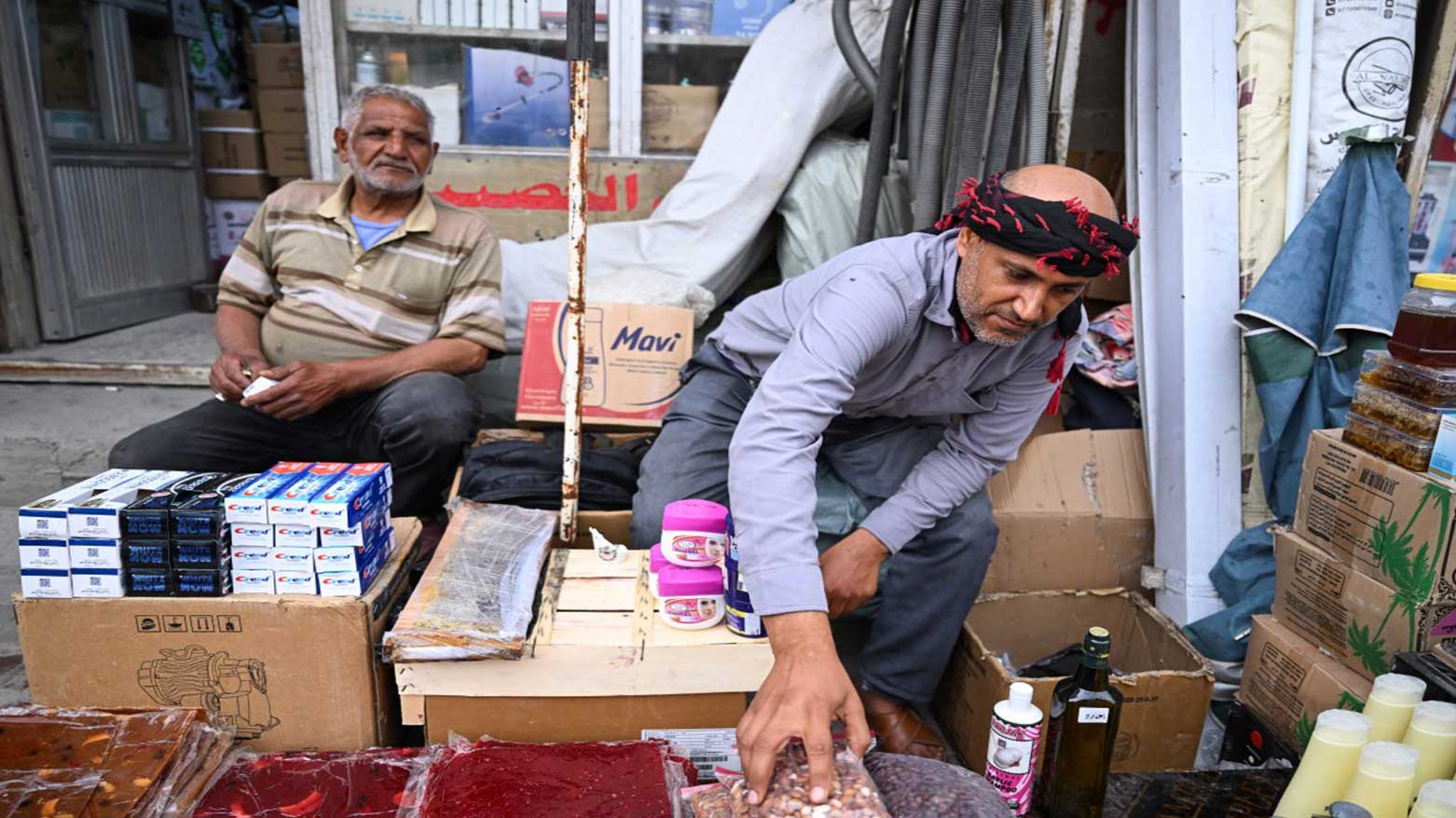 An Iranian street vendor sorts his stall at the old market in Iraq's southern city of Basra, April 4, 2025. (Photo: AFP)