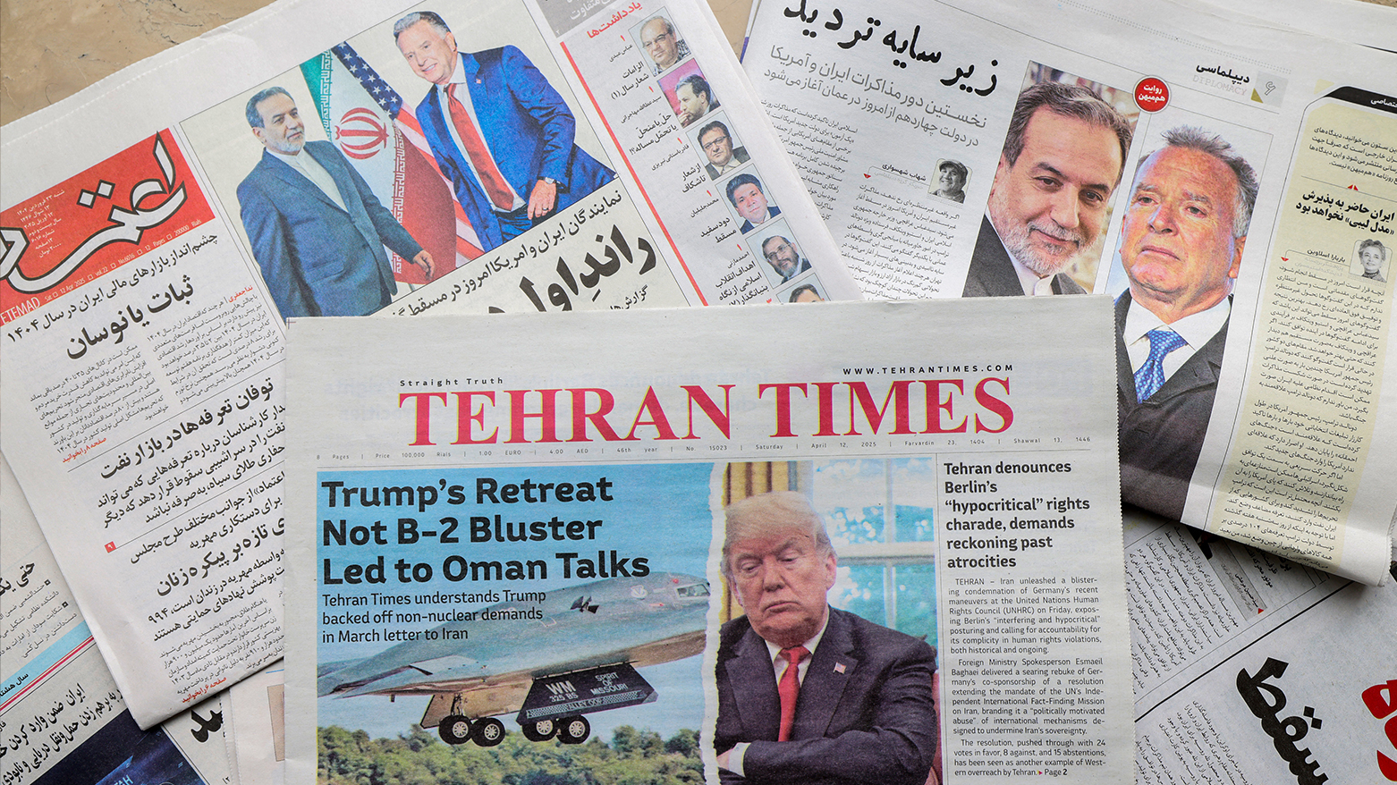 A picture shows newspaper front page headlines at a kiosk in Tehran on April 12, 2025, featuring the Iran-US talks on the Iranian nuclear programme set to begin in Oman on the same day. (Photo