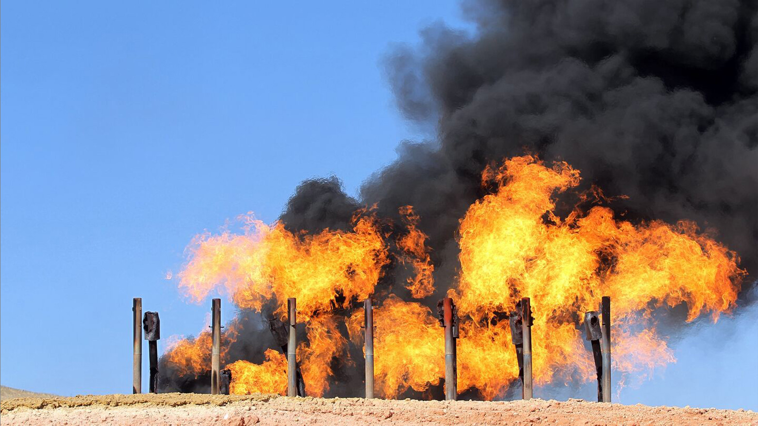 Excess flammable gasses burning from gas flares at the Havana oil field, west of the city of Kirkuk. (Photo: AFP)