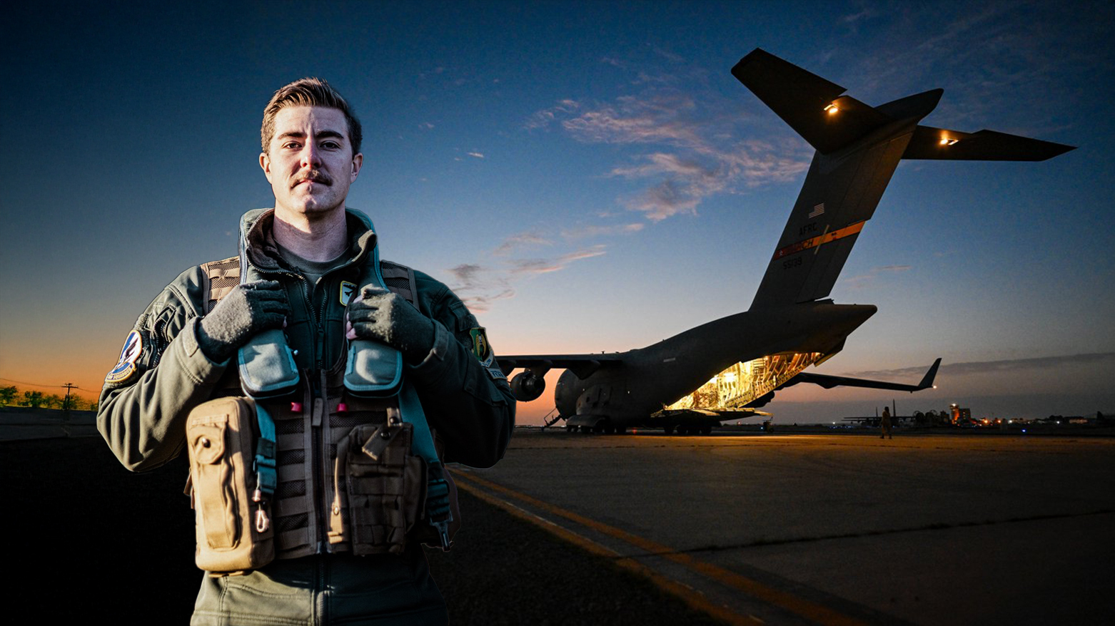 A huge U.S. military plane is seen behind a standing U.S. soldier. (Photo: NATO)