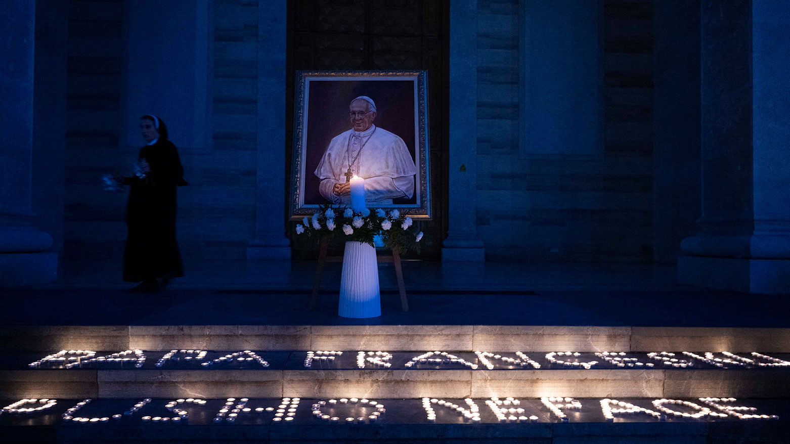 A Catholic nun walks past a portrait of the late Pope Francis displayed at the St. Mother Teresa Cathedral in Pristina on April 21, 2025. (Photo: AFP)