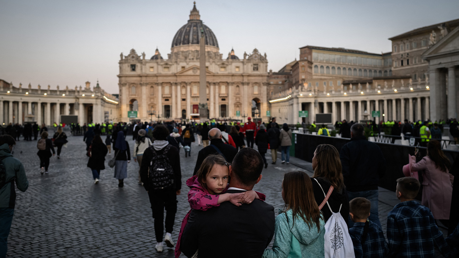 A man carries a girl near St. Peter’s Basilica in Rome ahead of late Pope Francis’ funeral on April 26, 2025. (Photo: AFP)