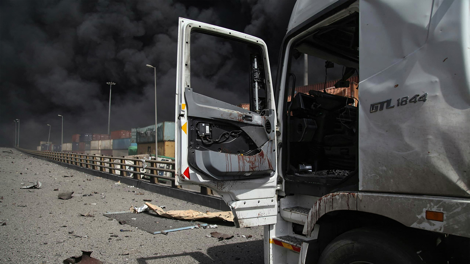 Blood stains a truck door as black smoke billows after the April 26 explosion at Shahid Rajaee Port near Bandar Abbas, Hormozgan province, Iran. (Photo: AFP)