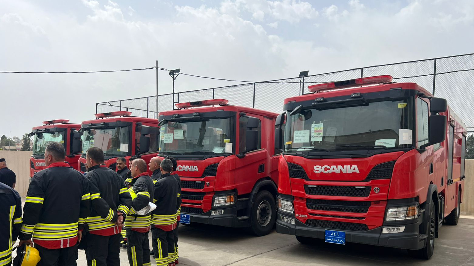 A firefighting brigade stands beside the newly deployed fleet of advanced firefighting vehicles. (Photo: Kurdistan24)