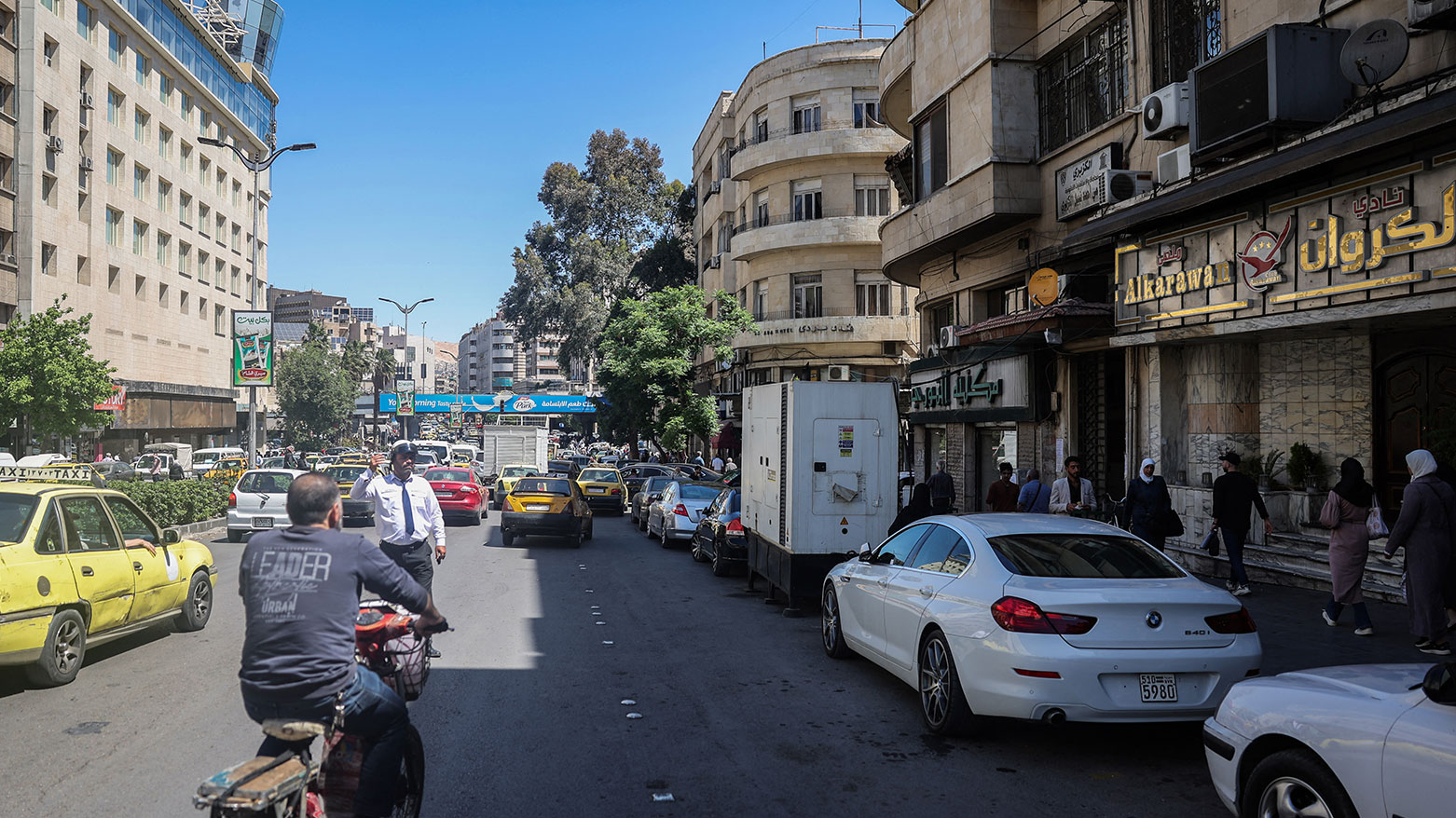 Vehicles drive past the closed entrance of al-Karawan nightclub, which was attacked by gunmen overnight, on Damascus' Saadallah al-Jabri street on May 5, 2025. (Photo: AFP)