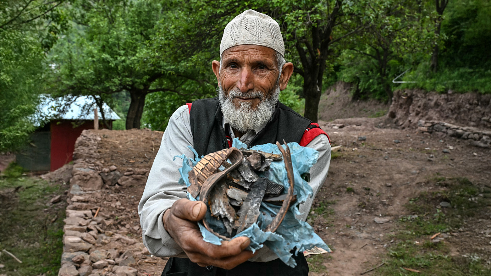 Mohammad Nazir Khan, a Kashmiri resident, shows splinters of a mortar shell that exploded near his house in Kalgi village in Uri, about 125kms from Srinagar, on May 8, 2025. (Photo: AFP)