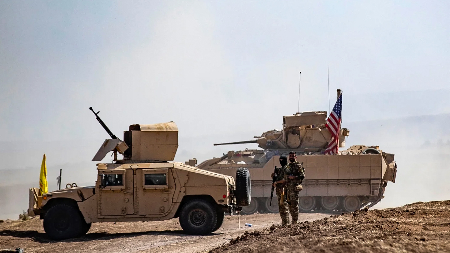 SDF fighters stand near a US Bradley Fighting Vehicle during a joint exercise with the US-led coalition against ISIS in al-Malikiya, Syria, on Sep. 7, 2022. (Photo: AFP)