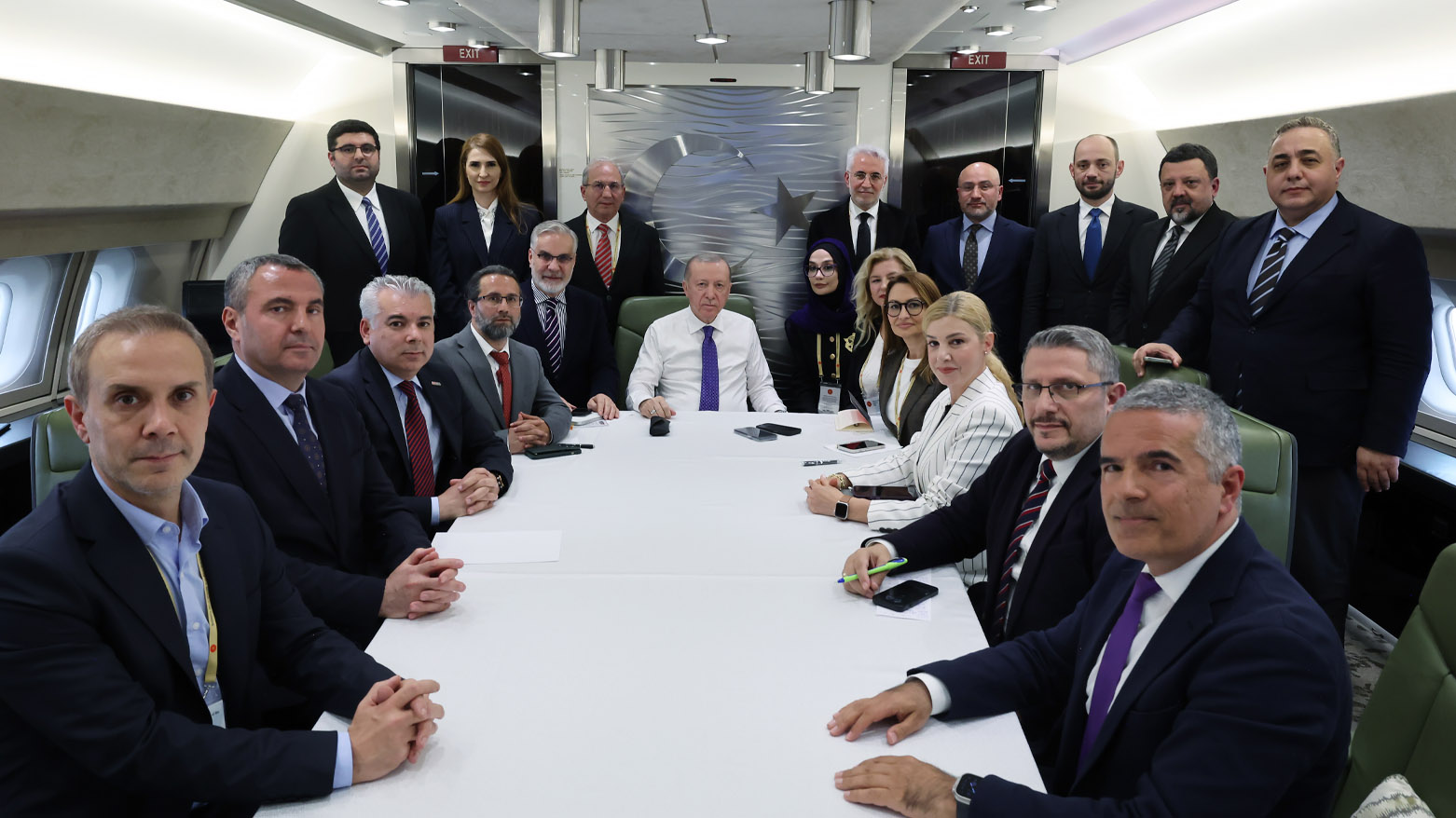 Turkish President Recep Tayyip Erdoğan among the reporters aboard the flight back to Türkiye. (Photo: AA)