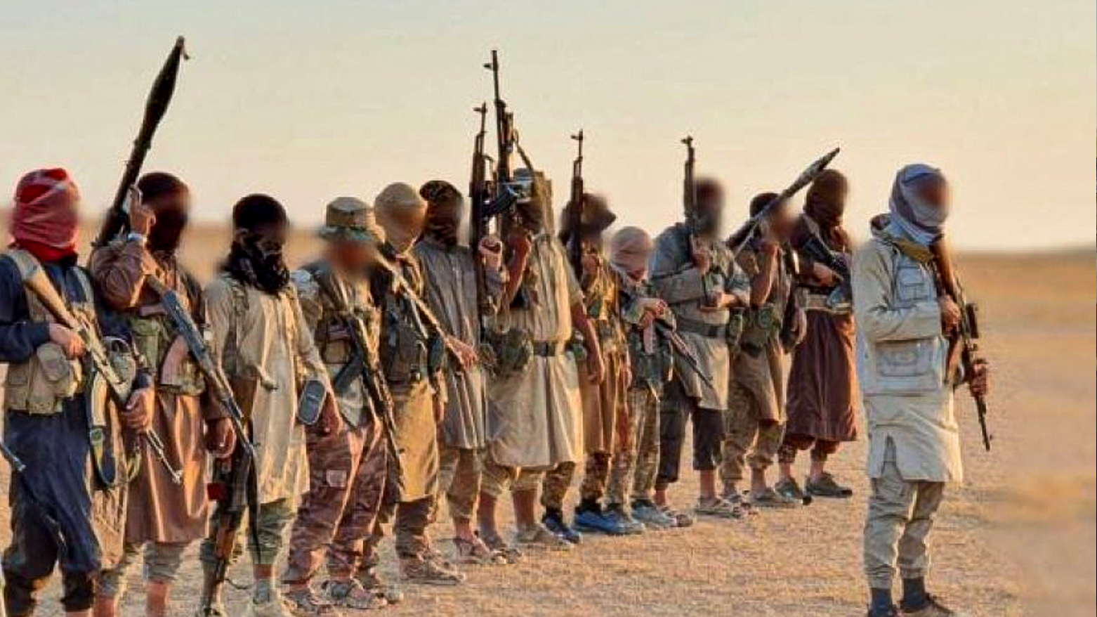 Unknown masked men carrying weapons. (Photo: SOHR)