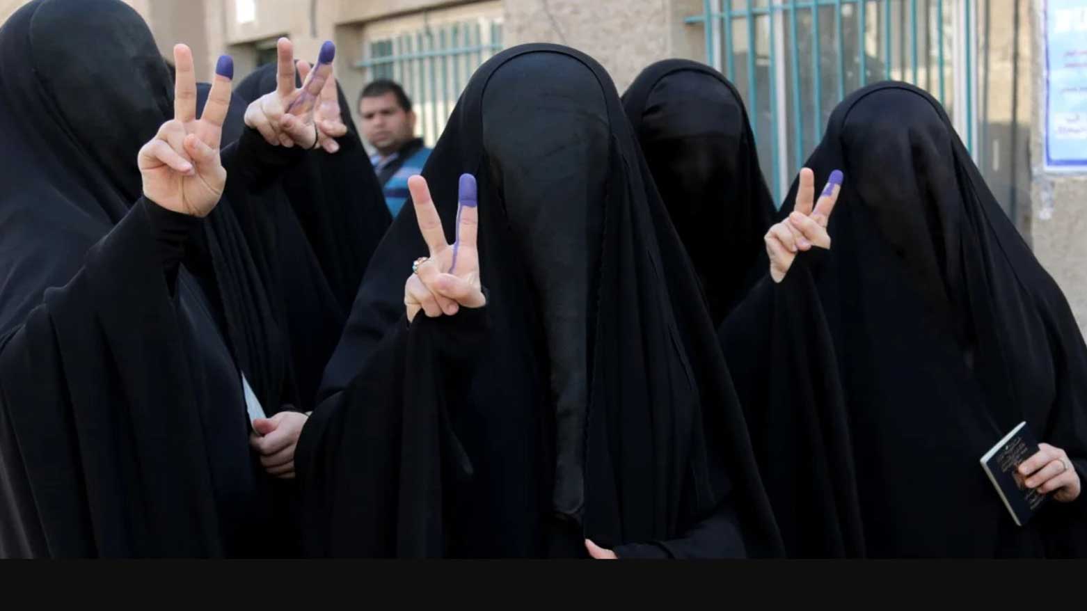 Iraqi women give victory signs while showing their inked fingers after voting in Baghdad, May 1, 2014. (Photo: AP)