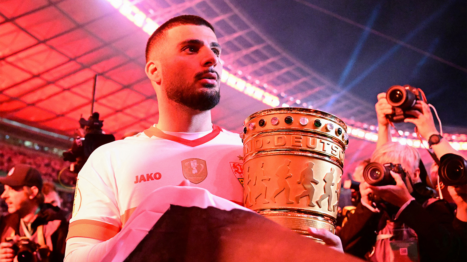 Stuttgart's Kurdish-German forward #26 Deniz Undav celebrates with the trophy. (Photo: AFP)