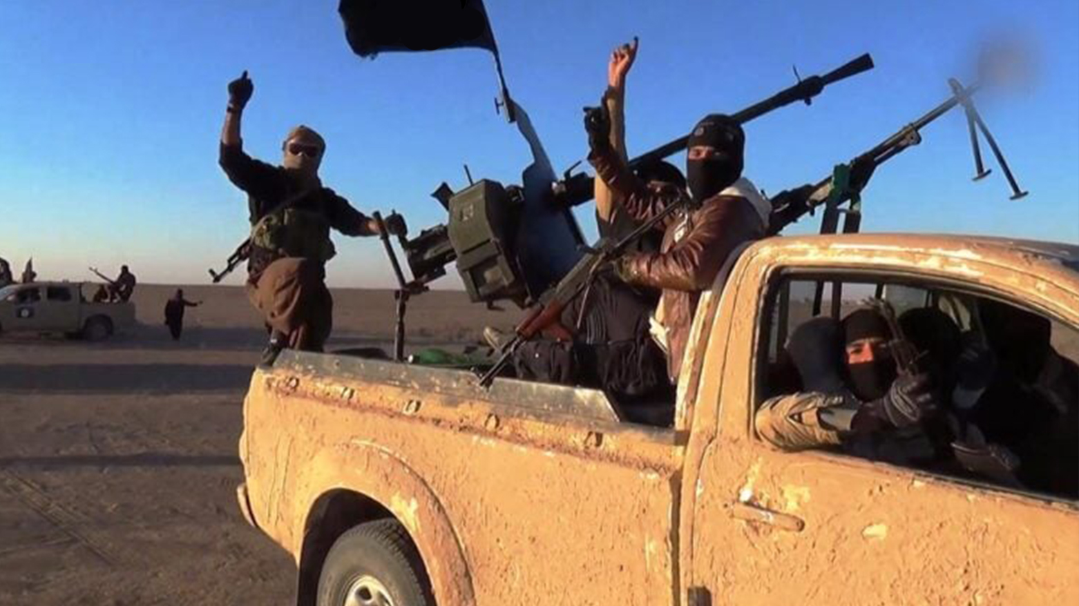 A group of unknown armed men affiliated with ISIS. (Photo: SOHR)