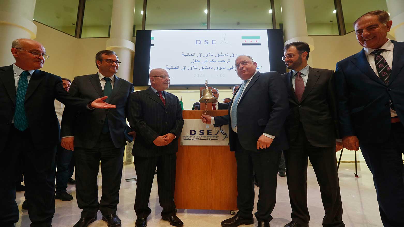 Syrian Finance Minister Mohammed Yisr Barnieh, center right, rings the opening bell at the Damascus Securities Exchange in Damascus, Syria, June 2, 2025. (Photo: AP)