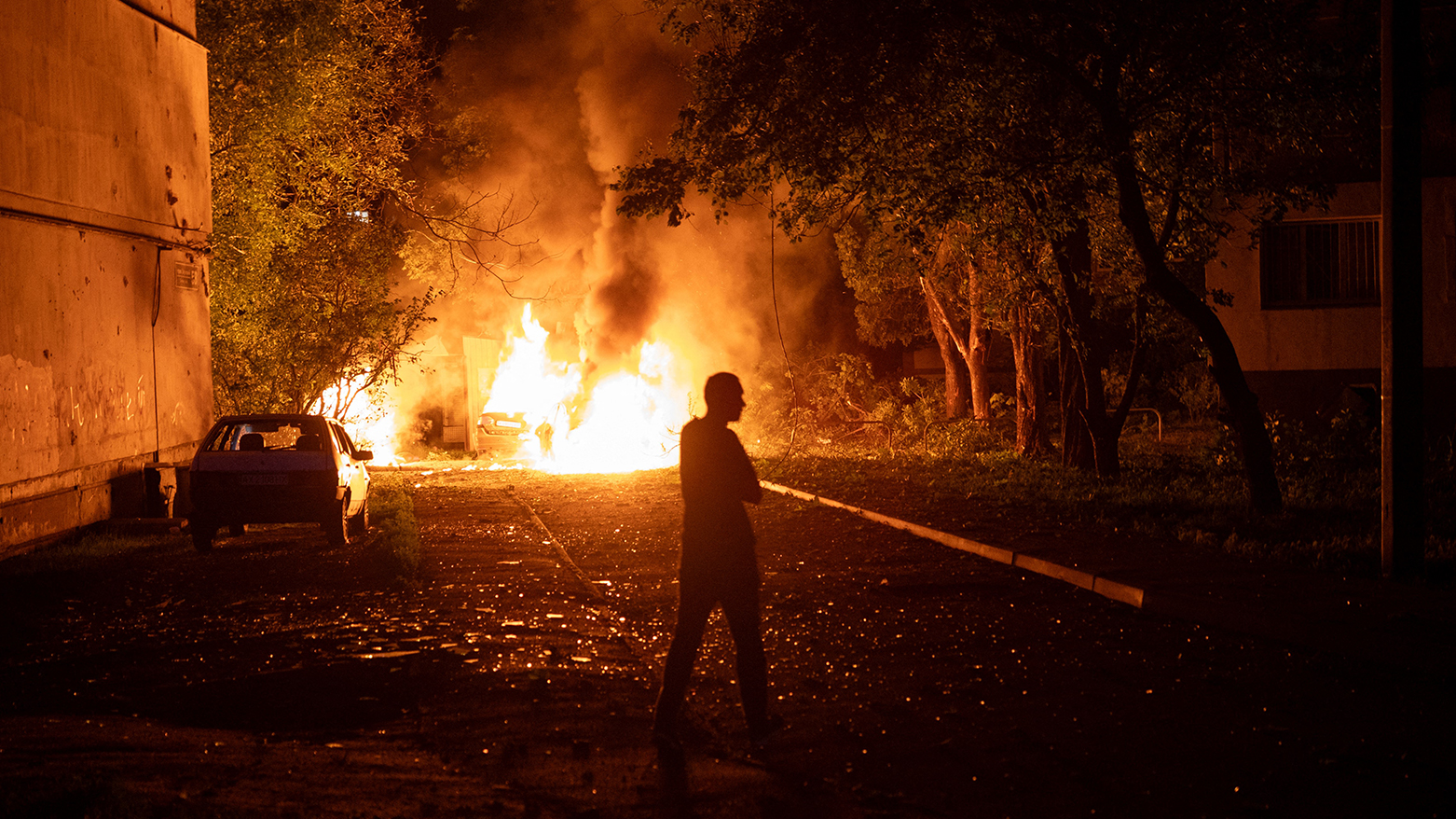 A man walks near a fire following a drone strike in Kharkiv on June 5, 2025, amid Russian invasion in Ukraine. (Photo: AFP)