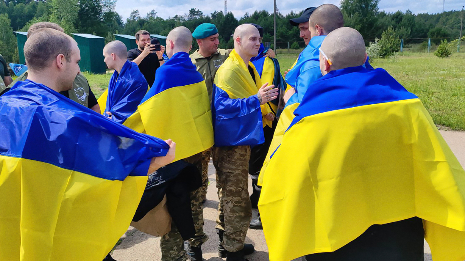 Ukrainian POWs wrapped in national flags after a prisoner exchange, June 9, 2025. (Photo: AFP)
