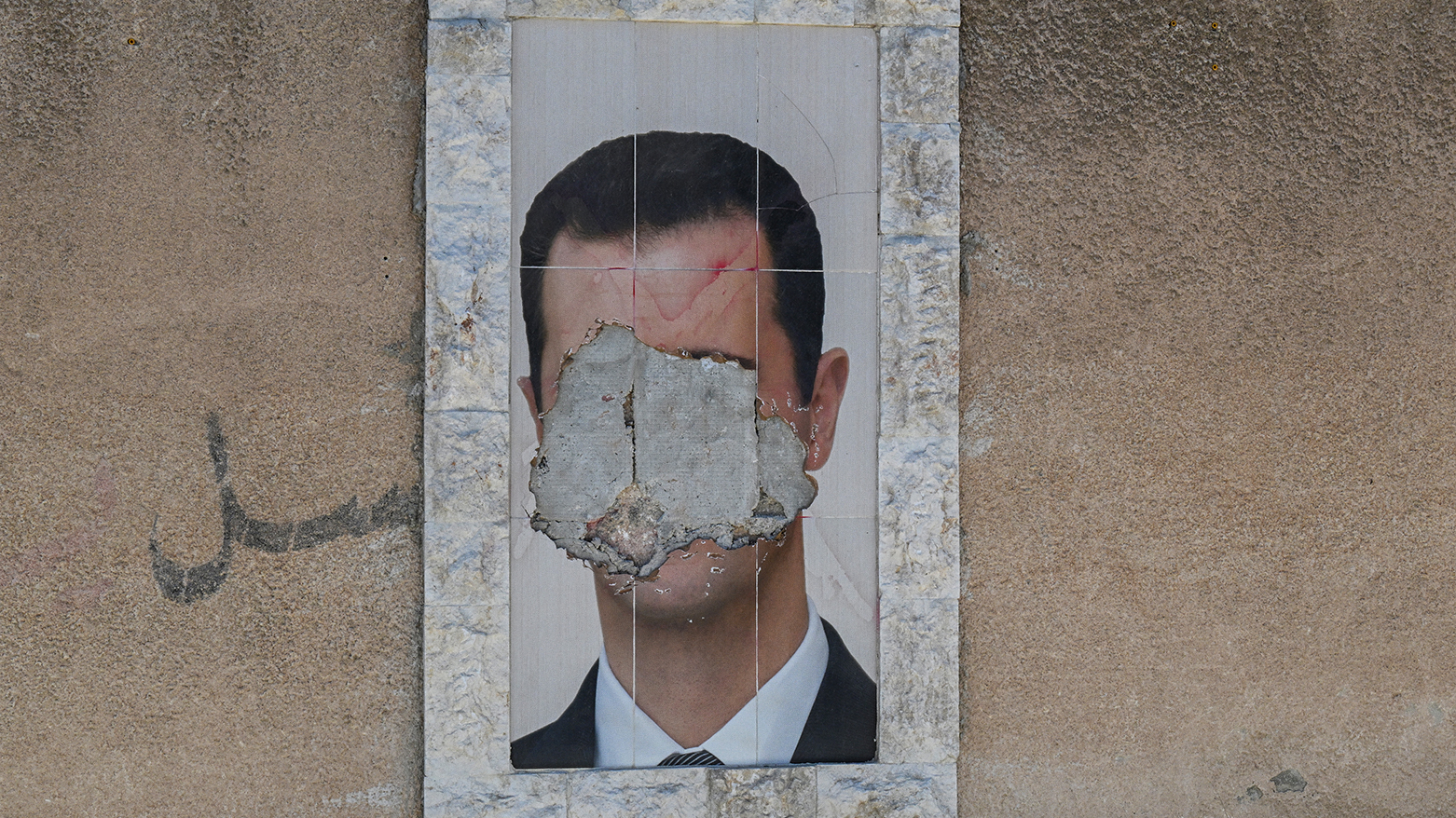 A defaced portrait of Syria's ousted president Bashar al-Assad. (Photo: AFP)