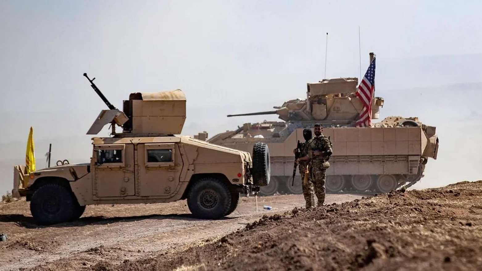 SDF fighters stand near a US Bradley Fighting Vehicle (BFV) during a joint military exercise with forces of the US-led coalition in the countryside of Derik in Syria's northeastern Hasakah province on Sep. 7, 2022. (Photo: AFP)