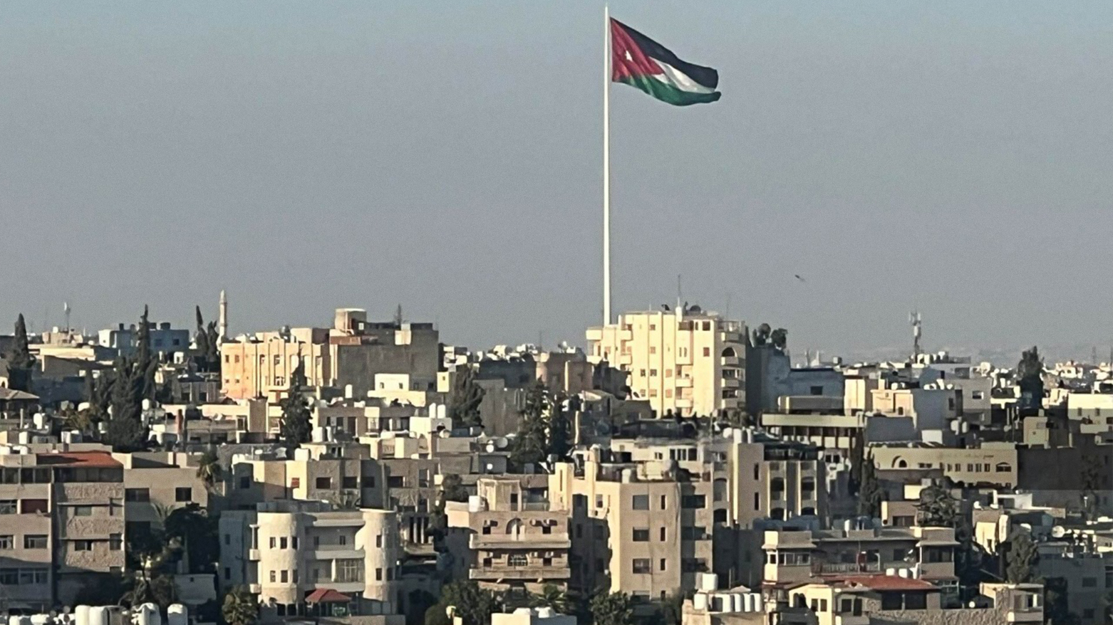 A picture taken on June 30, 2023, the Jordanian flag waves in the wind over the Jordanian capital Amman. (Photo: AFP)